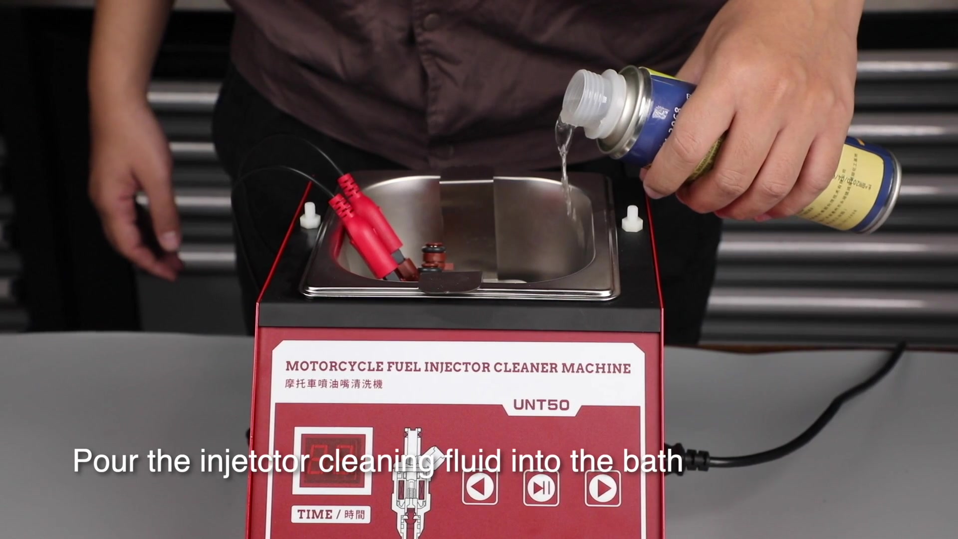 Cleaning liquid being poured into the UNT50 bath around supported injectors