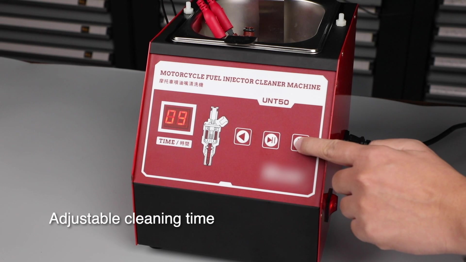 Operator pressing an UNT50 time button while the display shows a selected duration