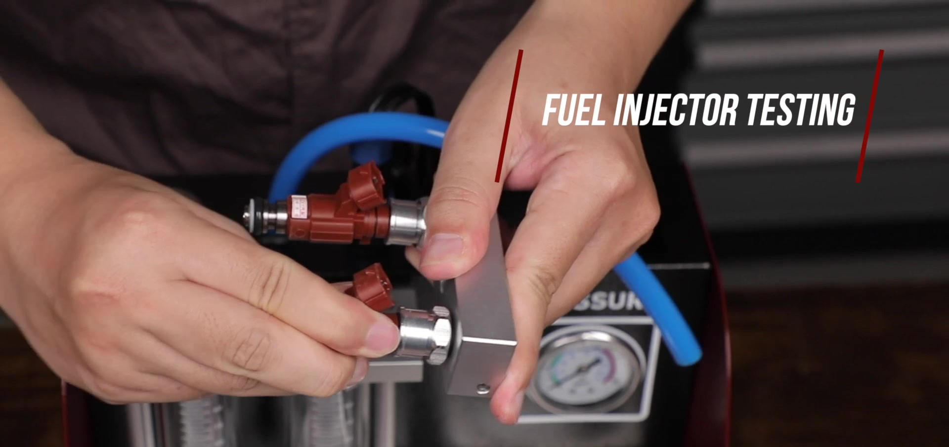 Operator fitting two motorcycle fuel injectors into the UNT60 top-feed test adapters