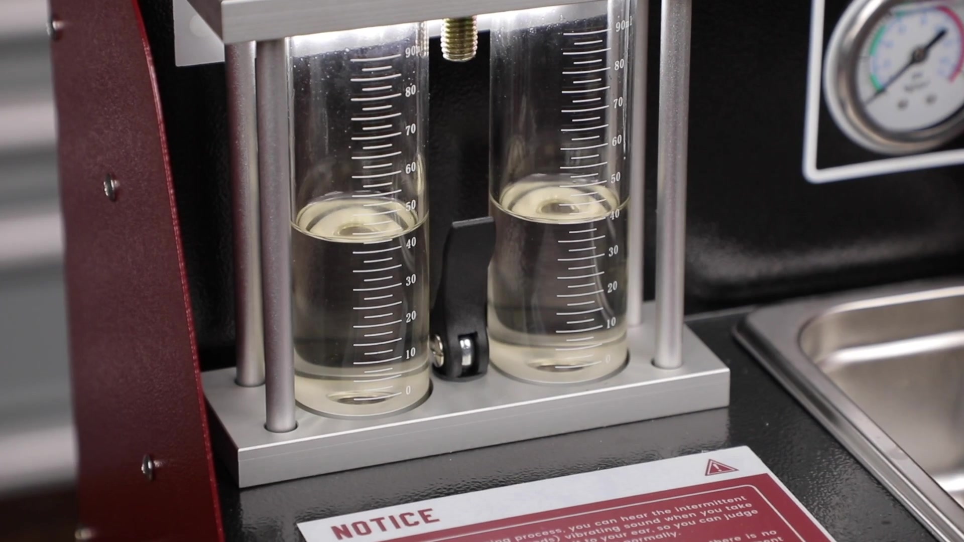 Two UNT60 glass measuring cylinders holding similar but separately readable test-fluid volumes