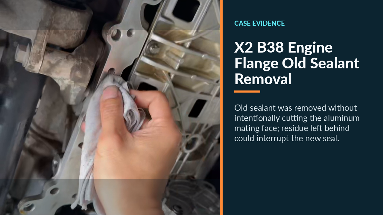 Old sealant being removed from the BMW B38 engine-side oil-pan flange.